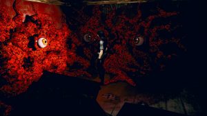 A woman is standing in a room with fleshy walls. Eyeballs inside the flesh are staring at the woman.