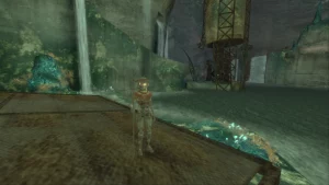 A place below the ground with smaller metal structures and lots of flowing water. A robot is standing on a platform.