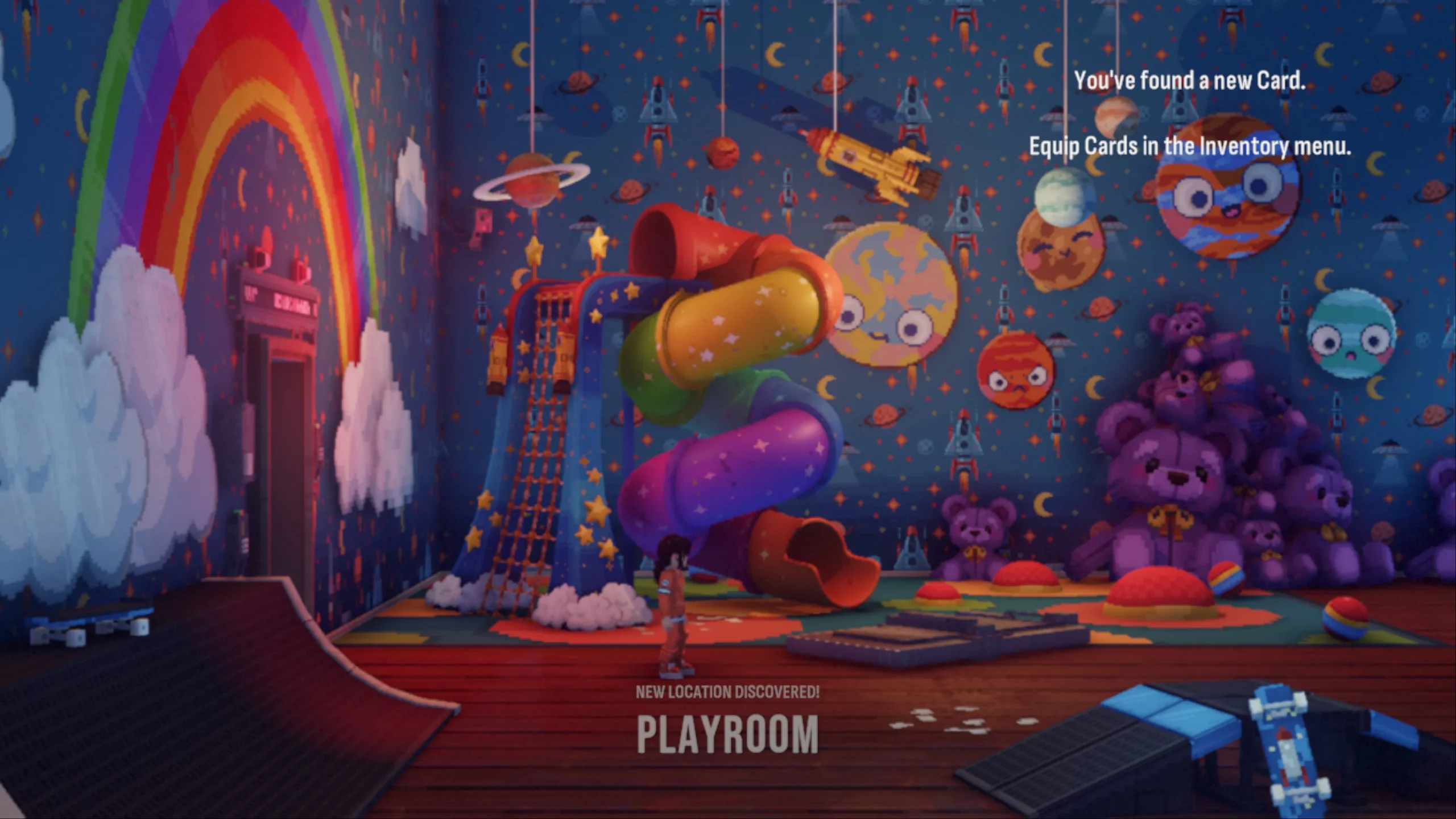 A very colourful playroom. A slide, lots of teddy bears and a skate board are in the room. 