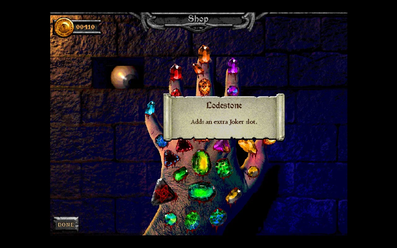 A hand with many gems. One says: "Lodestone - Adds an extra Joker slot."